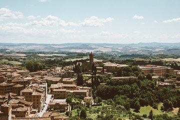 Fototapeta na wymiar Panoramic view of Siena city with historic buildings and far away green fields
