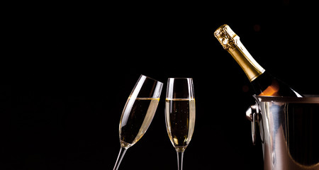 Champagne glasses on black background. Holiday celebration concept.