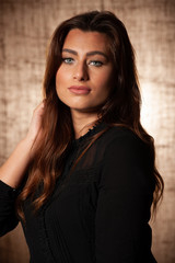 Fototapeta premium BBeauty portrait of cute brunette woman with blue eyes over grunge brown background