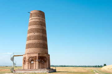 Tokmok, Kyrgyzstan - Aug 08 2018: Ruins of Burana Tower in Tokmok, Kyrgyzstan. It is part of the World Heritage Site - Silk Roads: the Routes Network of Chang'an-Tianshan Corridor.