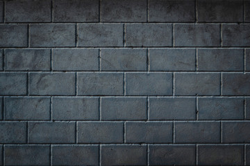 Background of smoothly laid cinder blocks. Wall of bricks with vignetting.