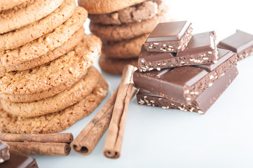 Various shortbread, oat cookies, chocolate chip biscuit and pieces of chocolate with seeds and nuts.