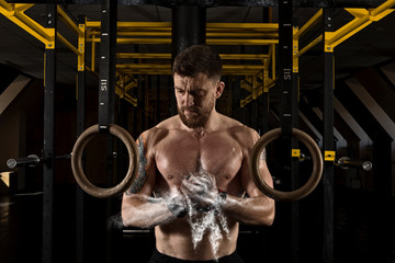 Fototapeta na wymiar Muscular man clapping hands and preparing for workout