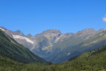 Fototapeta na wymiar Panorama view of mountains scenes in national park Dombay, Caucasus