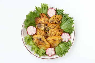 Chicken liver in batter is located on a plate on a white background