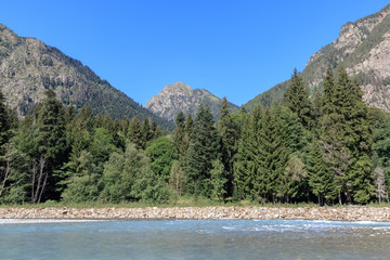 Fototapeta na wymiar Panorama view of river scene in mountains of national park Dombay, Caucasus