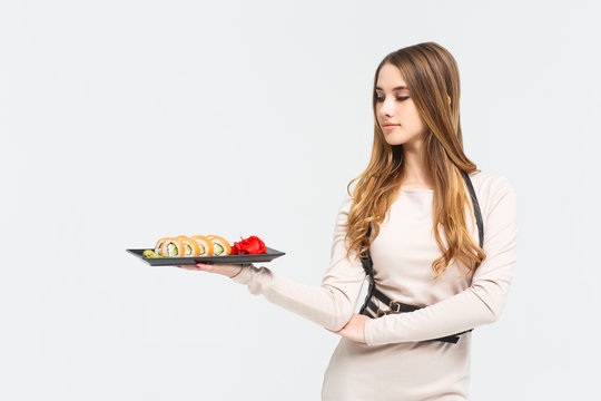 Surprised and happy young girl with sushi on white  background with copy space.