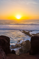 Spain, Lanzarote, Romantic orange sunset sky over el golfo giant waves at west coast