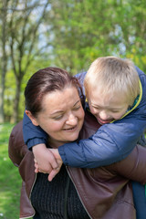 Defect,childcare,medicine and people concept: Happy mother and son with down syndrome playing...