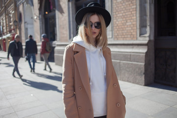 Fototapeta premium Charming young blonde on a walk. Young beautiful woman in stylish look