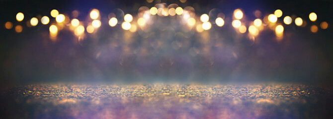 glitter vintage lights background. black, purple, blue and gold. de-focused