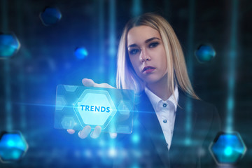 The concept of business, technology, the Internet and the network. A young entrepreneur working on a virtual screen of the future and sees the inscription: Trends