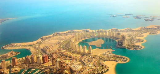 Fotobehang Aerial view of the Pearl-Qatar, the artificial island in Persian Gulf, Doha, Qatar, Middle East. Scenic flight of Viva Bahriya in Maghreb and Moorish style and exclusive Dana Island. Banner panorama. © bennymarty
