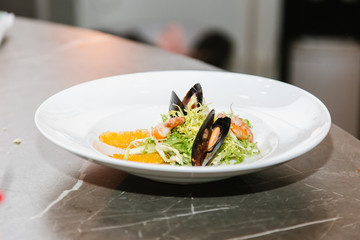 seafood salad: shrimp, mussels, cabbage, sauce, vegetables, tomatoes, orange