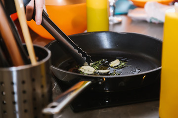 Garlic and herbs fried in butter in a pan