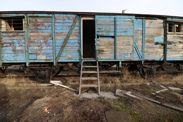 Fototapeta na wymiar Abandoned old railway wagons at station, old train wagons in an abandoned station Inside this train station still stay wagons since the station was closed.