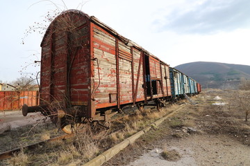 Fototapeta na wymiar Abandoned old railway wagons at station, old train wagons in an abandoned station Inside this train station still stay wagons since the station was closed.