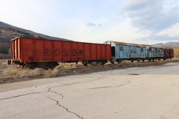   Abandoned old railway wagons at station, old train wagons in an abandoned station Inside this train station still stay wagons since the station was closed.