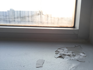 cracked floor near window at factory,dilapidated building,broken floor,Grunge surface with cracked silver paint