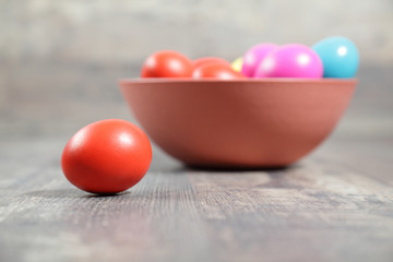 Multicoloured Easter eggs in a clay bowl