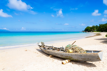 Fototapeta na wymiar Boat on the beach at sunny summer day, Mahe, Seychelles
