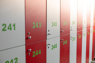 red-white metal cabinets  gym with locks and numbers. close up photo