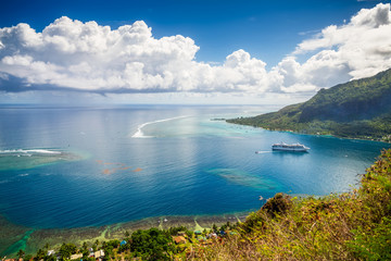 Panoramic lagoon view from the top of the hill Mount Rotui. Paradise Beach coastline seascape with boat, road and palm trees at Moorea, Tahiti French Polynesia - obrazy, fototapety, plakaty