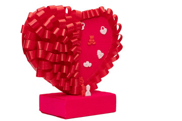 Toys for men and women next to a big red heart on a white background. Family figurines close up....