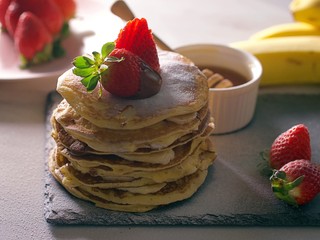 American pancakes with chocolate strawberries and banana