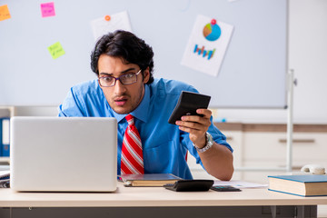 Young male financial manager working in the office 