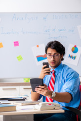 Young male financial manager working in the office 