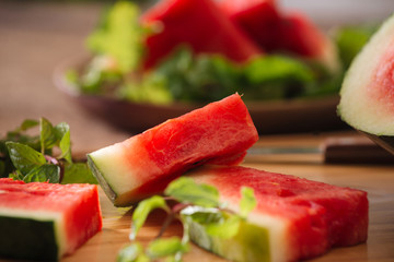 Sliced watermelon on the wood background