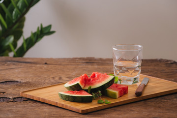 Sliced watermelon with pure water on the wood backgroud