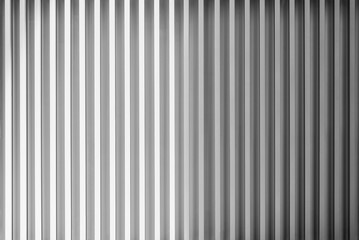 Photo of silver or grey metal sheet pattern decorated on wall. Modern material pattern wallpaper.