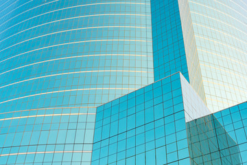 Abstract background from blue glasses window on modern building with reflection of blue sky.
