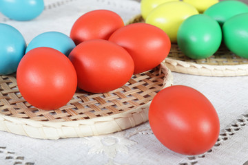 Multicoloured Easter eggs on wicker straw stand