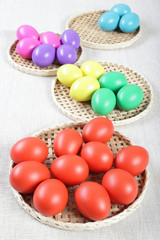 Multicoloured Easter eggs on wicker straw stands