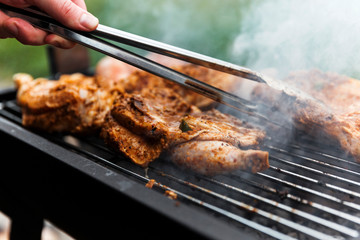 Home cook checking chicken before turning on barbecue.