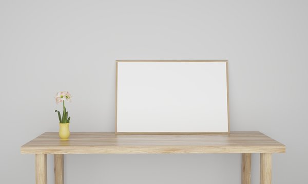 Empty white frame on table with white wall and a flower in pot 3D illustration
