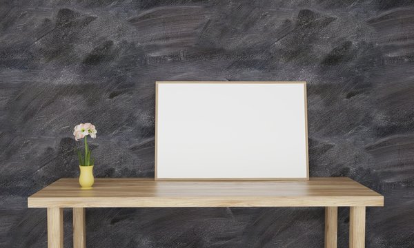 Empty white frame on table with black wall and a flower in pot 3D illustration