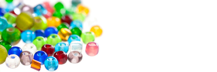 Close up on colorful translucent beads isolated on panoramic white background