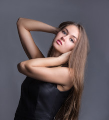 confident young woman in fashionable dress. isolated on grey