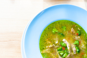 beef soup with colorfull vegetables at blue dish. lunch concept