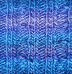 Texture of knitted blue fabric. Sweater material. 