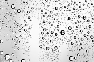 white isolated background water drops on the glass / wet window glass with splashes and drops of water and lime, texture autumn background