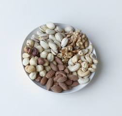 Healthy food. Nuts mix assortment on stone table top view. Collection of different legumes for background image close up nuts, pistachios, almond, cashew nuts, peanut, walnut. image