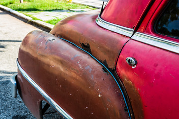 Rusty american classic car parked on the street.