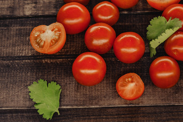tasty cherry tomatoes on a wooden stand, wooden background