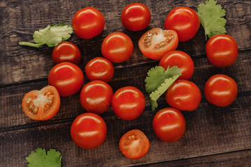 tasty cherry tomatoes on a wooden stand, wooden background