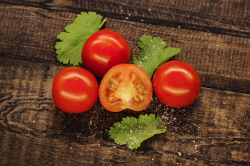 tasty red cherry tomatoes on wooden background.